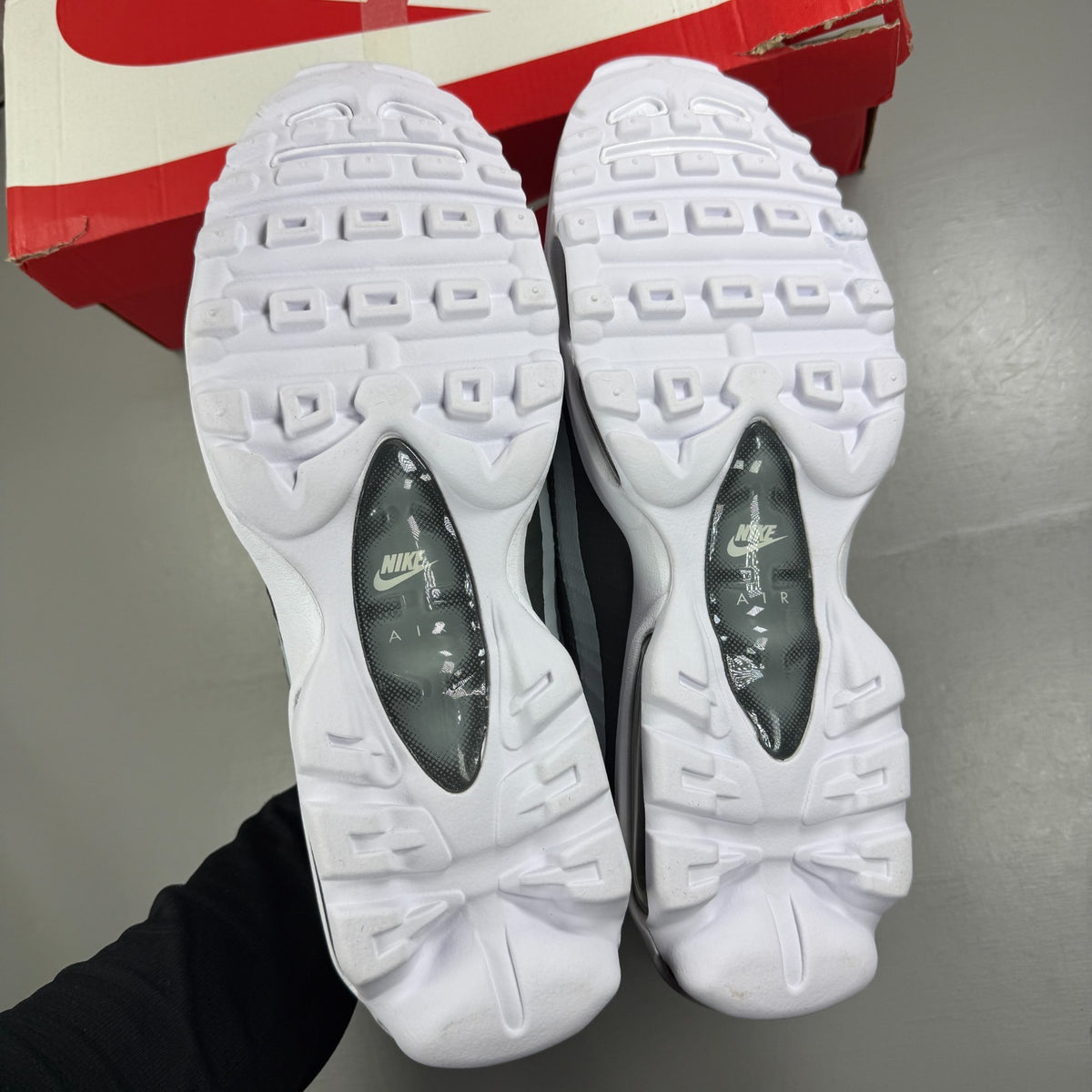 Nike running shoes white with grey accents and Air Max cushioning design.