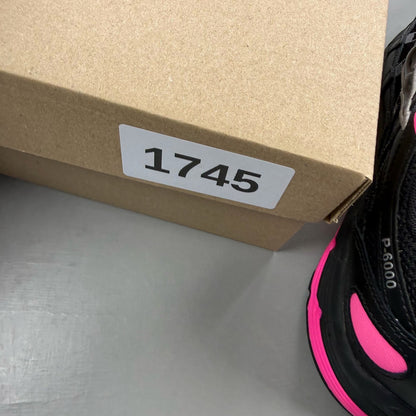 Nike P-6000 trainers black pink metallic detailing and logo accents.