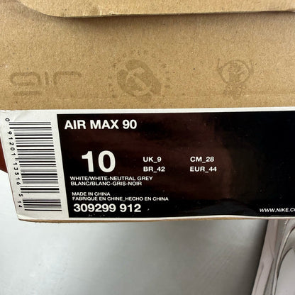 Nike Air Max 90 white trainers with grey accents and logo detailing.