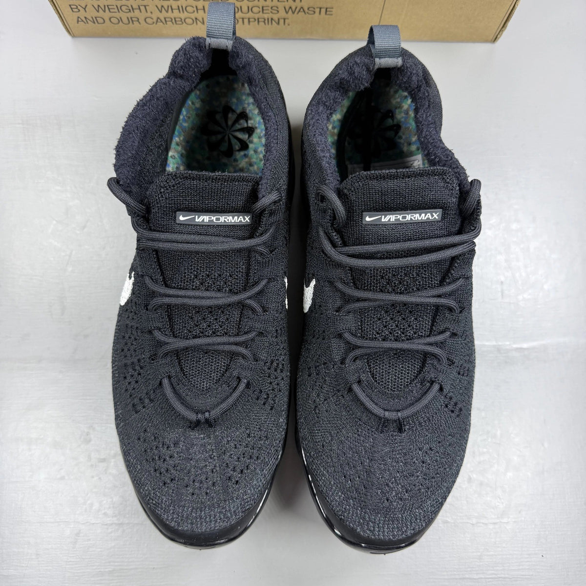 Nike black Air VaporMax trainers with Flyknit upper and signature swoosh logo.