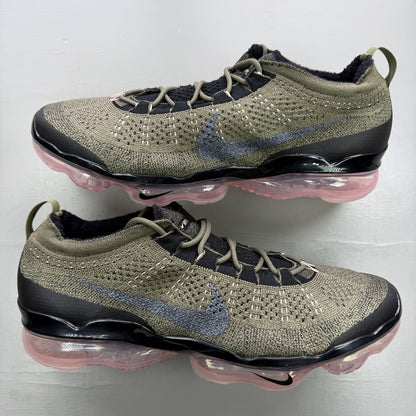 Nike trainers green Flyknit upper with pink accents and Air cushioning.