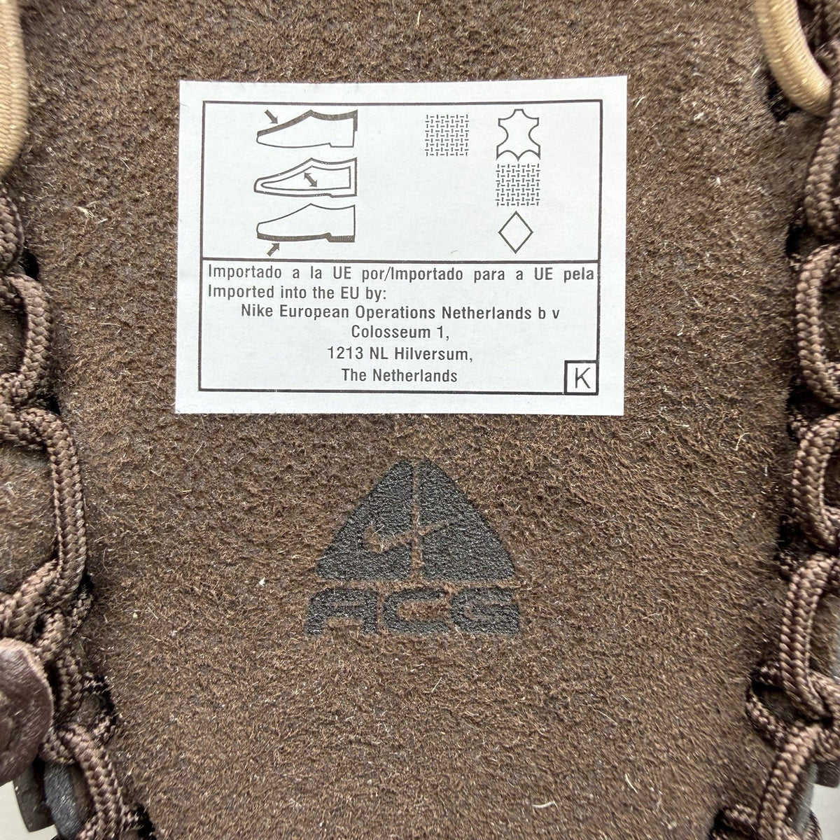 Nike ACG Valkyrie CI slides dark cinder brown with logo detail and textured material.