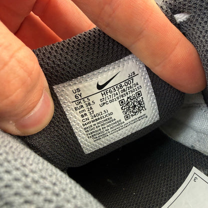 Nike Air Max 90 grey trainers with leather upper and signature swoosh logo.