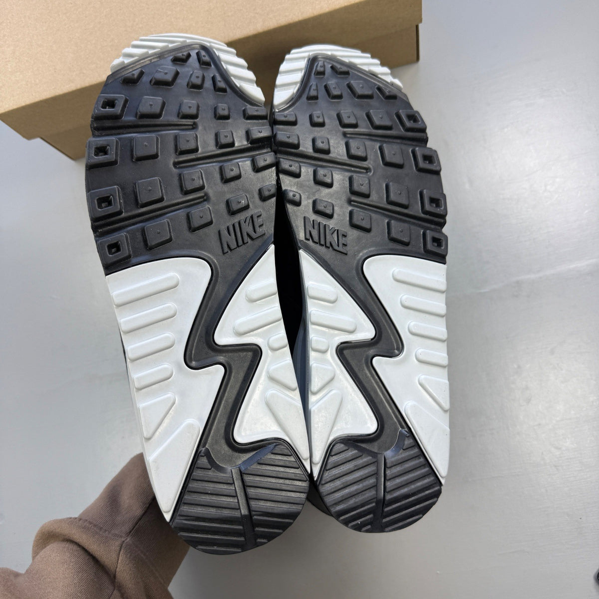 Nike trainers grey with black accents and logo, featuring a sleek design and breathable material.