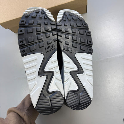 Nike trainers grey with black accents and logo, featuring a sleek design and breathable material.
