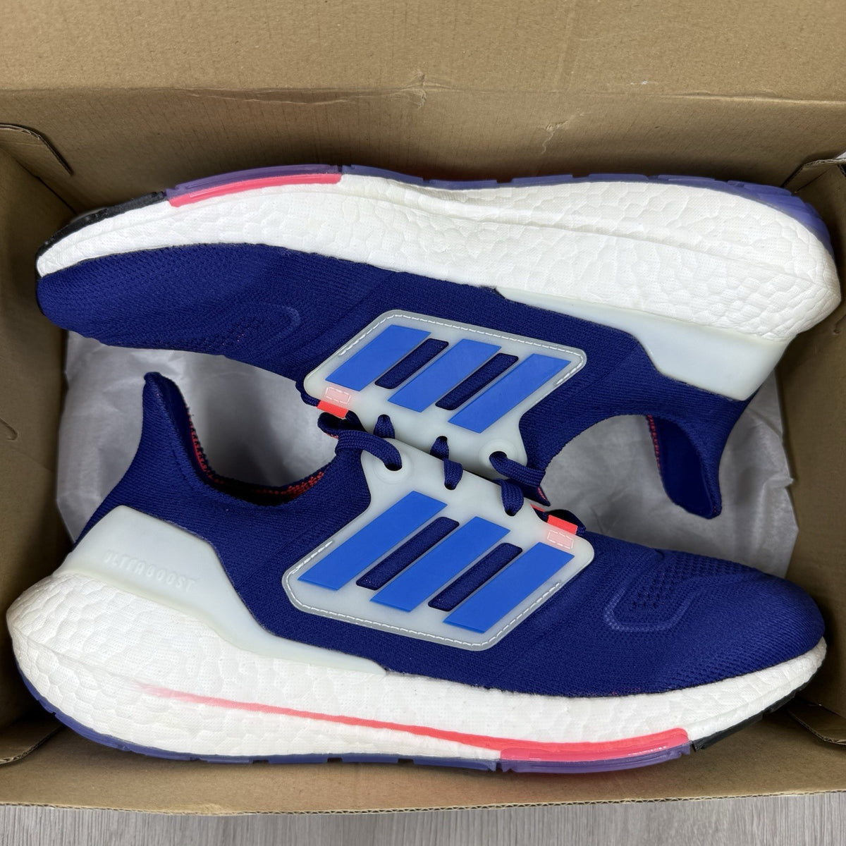 Adidas Ultra Boost 22 trainers in legacy indigo with turbo blue and white accents.