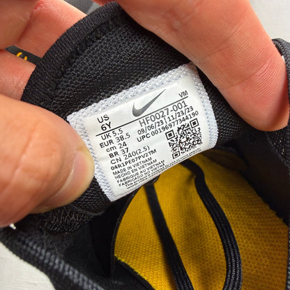 Nike black Air Max 270 trainers with grey and university gold accents, logo on tongue.