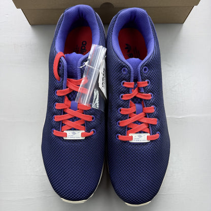 Adidas blue ZX Flux trainers with red and white woven pattern, logo on tongue.