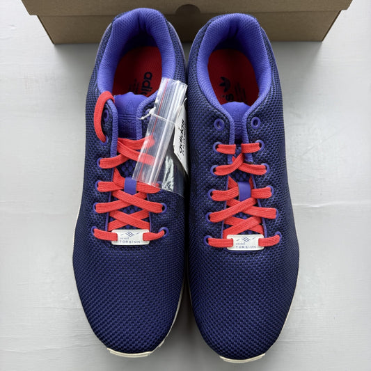Adidas blue ZX Flux trainers with red and white woven pattern, logo on tongue.
