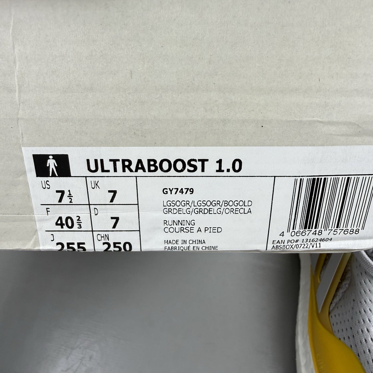 Adidas Ultra Boost 1.0 grey trainers with bold gold accents and white sole.