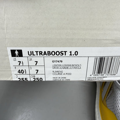 Adidas Ultra Boost 1.0 grey trainers with bold gold accents and white sole.
