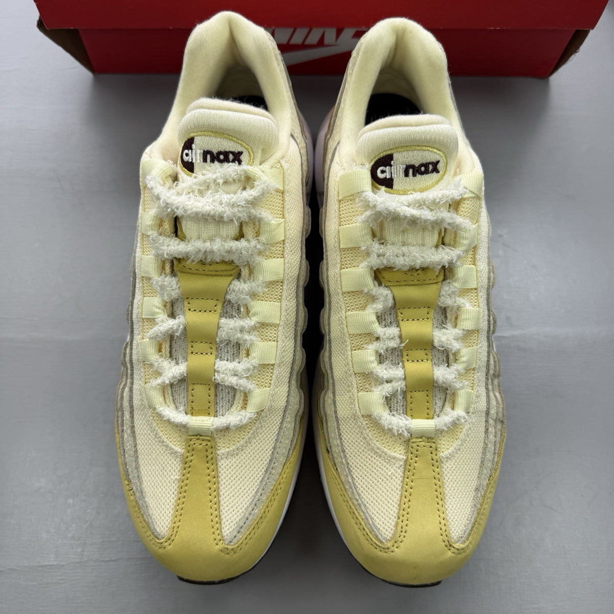 Nike Air Max 95 trainers yellow with textured upper and signature swoosh logo.