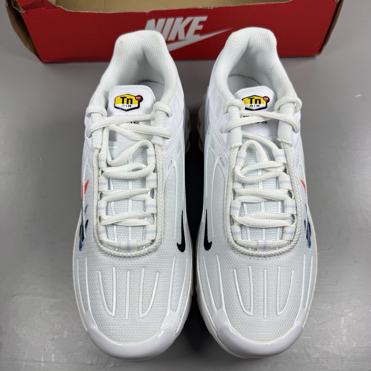 Nike Air Max Plus 3 white trainers with multi Swoosh logo and breathable mesh upper.