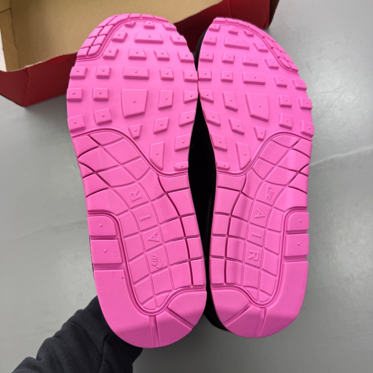 Nike trainers black with playful pink accents and Air Max cushioning.
