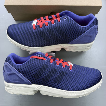 Adidas blue ZX Flux trainers with red and white woven pattern, logo on tongue.