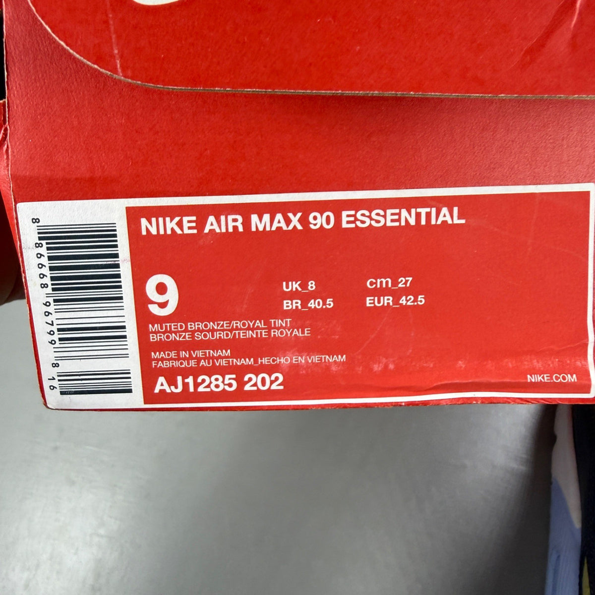 Nike black trainers with muted bronze accents and Air Max cushioning design.