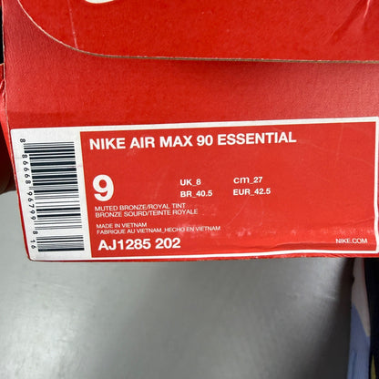 Nike black trainers with muted bronze accents and Air Max cushioning design.