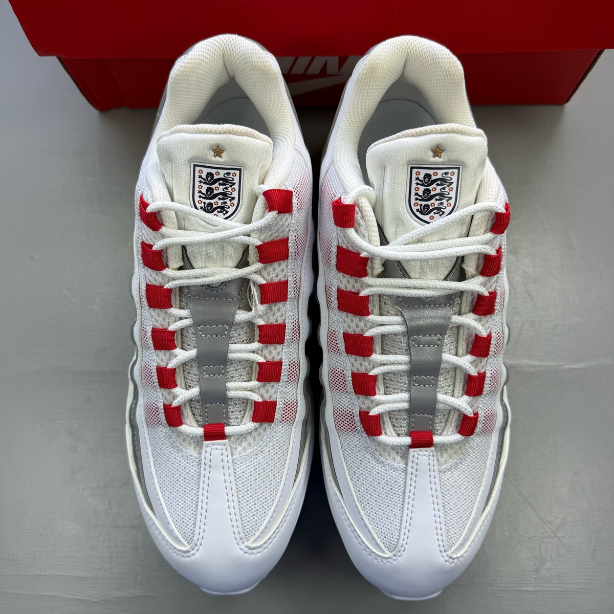 Nike Air Max 95 white sneakers with signature big bubble sole and logo detail.