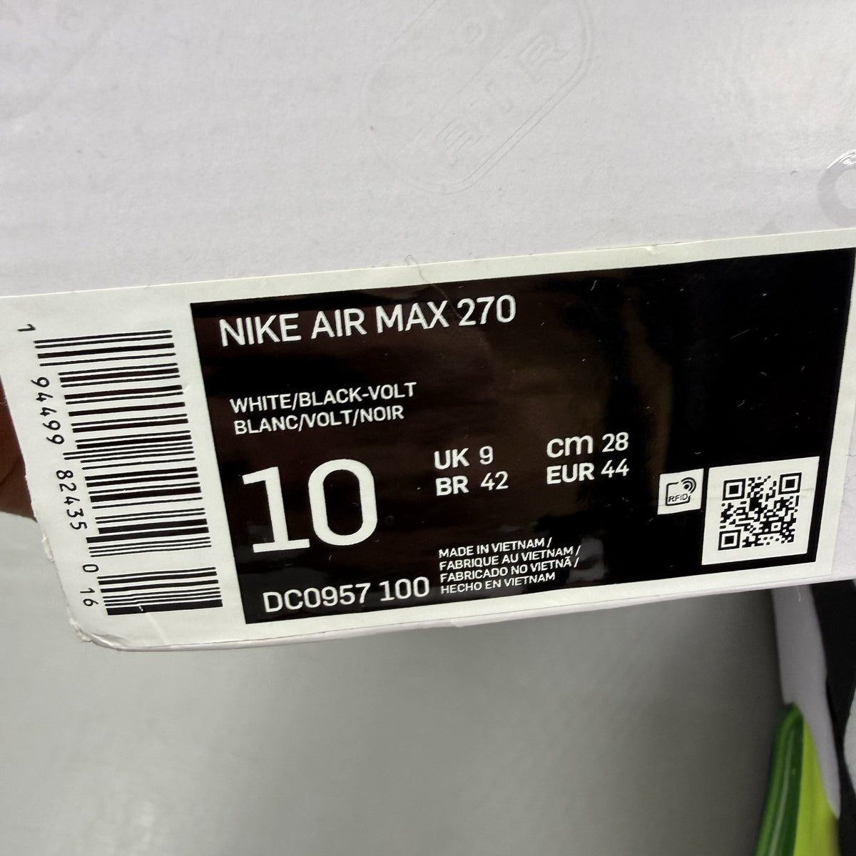 Nike Air Max 270 black trainers with white and volt green accents, mesh material.