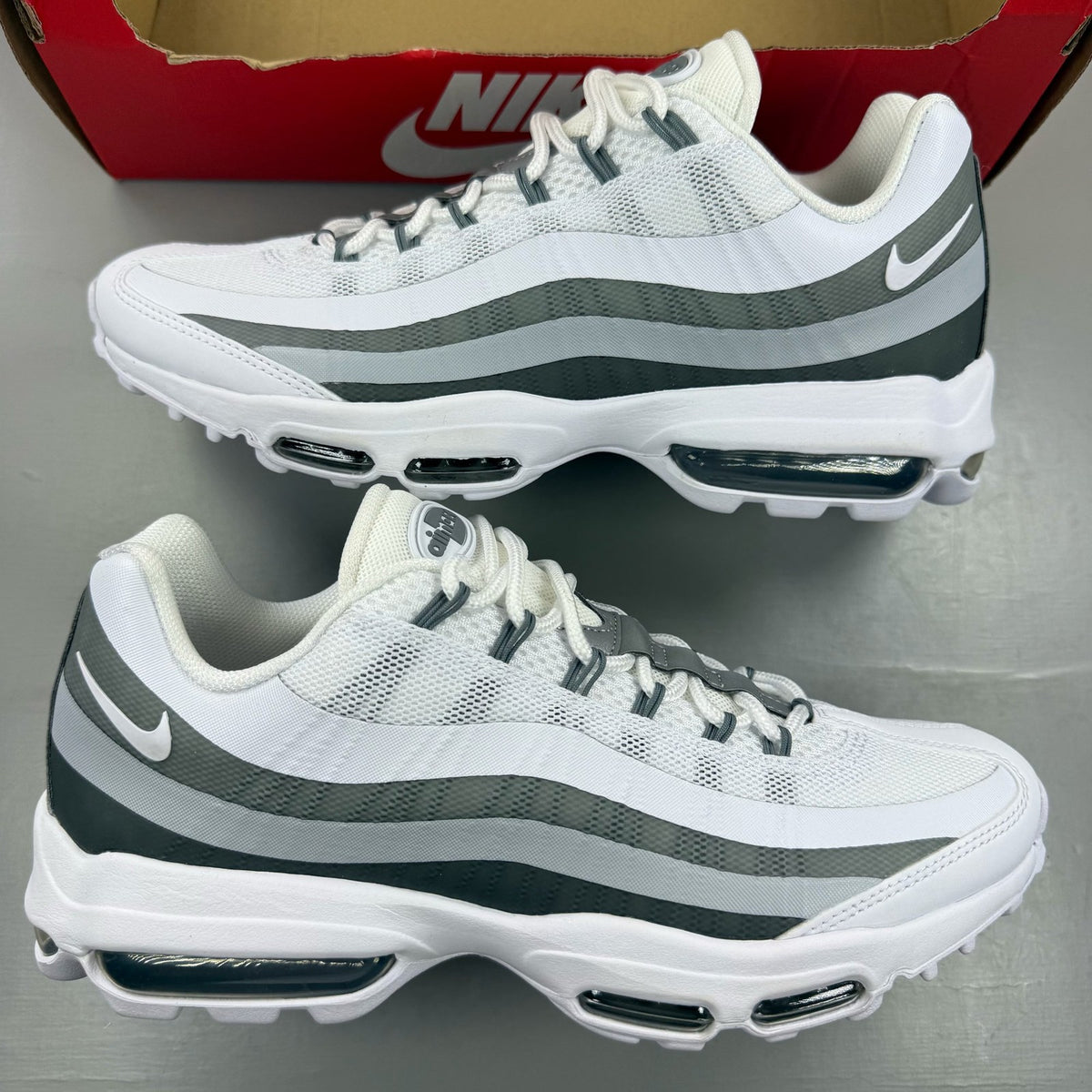 Nike Air Max 95 Ultra white trainers with grey accents and signature logo details.
