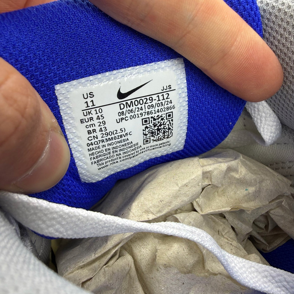 Nike Air Max 90 white trainers with hyper royal blue and grey accents.