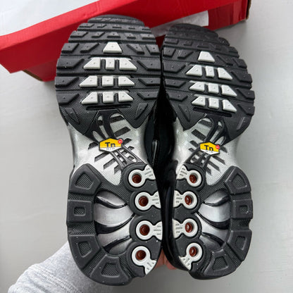Nike black trainers suede material with silver accents and iconic Air Max Plus design.