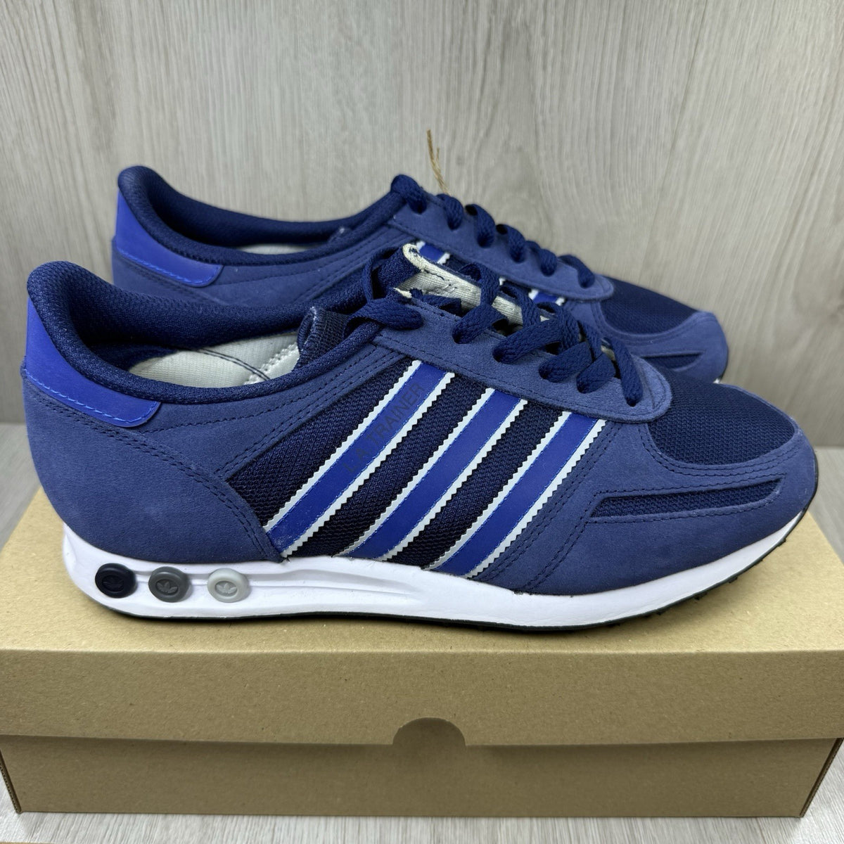 Adidas blue LA Trainers with white stripes and logo detailing on the side.