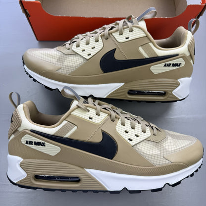 Nike Air Max 90 Drift beige trainers with white accents and logo detailing.