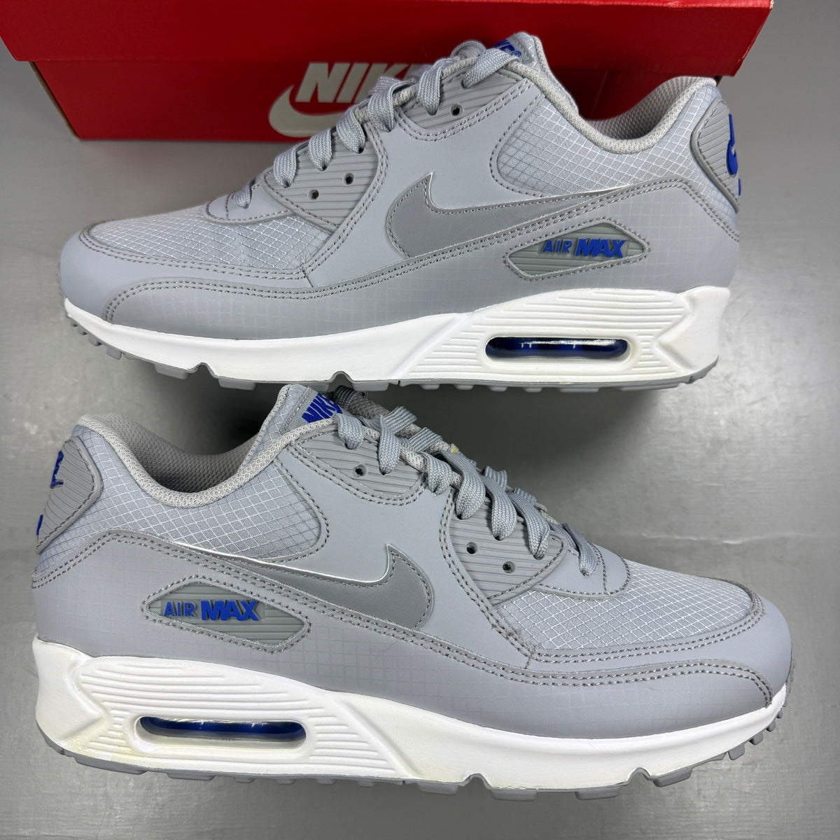 Nike running shoes grey mesh upper with white accents and signature swoosh logo.