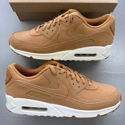 Nike Air Max 90 brown trainers with premium suede material and iconic swoosh logo.