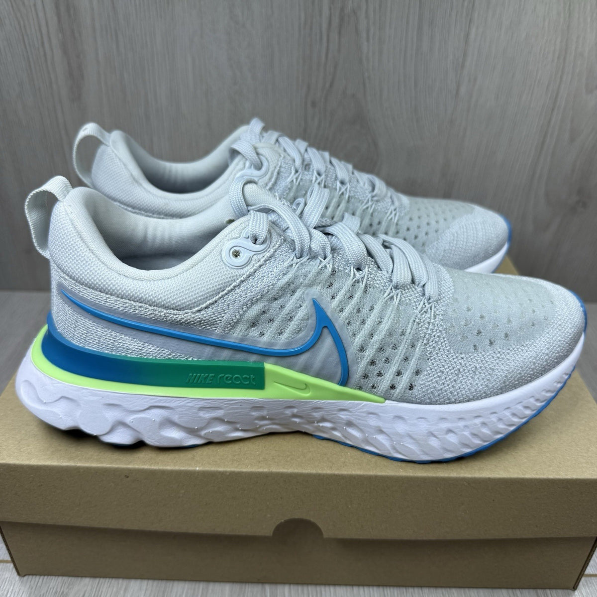 Nike React Infinity Run Flyknit 2 trainers blue grey white with Flyknit upper and logo.