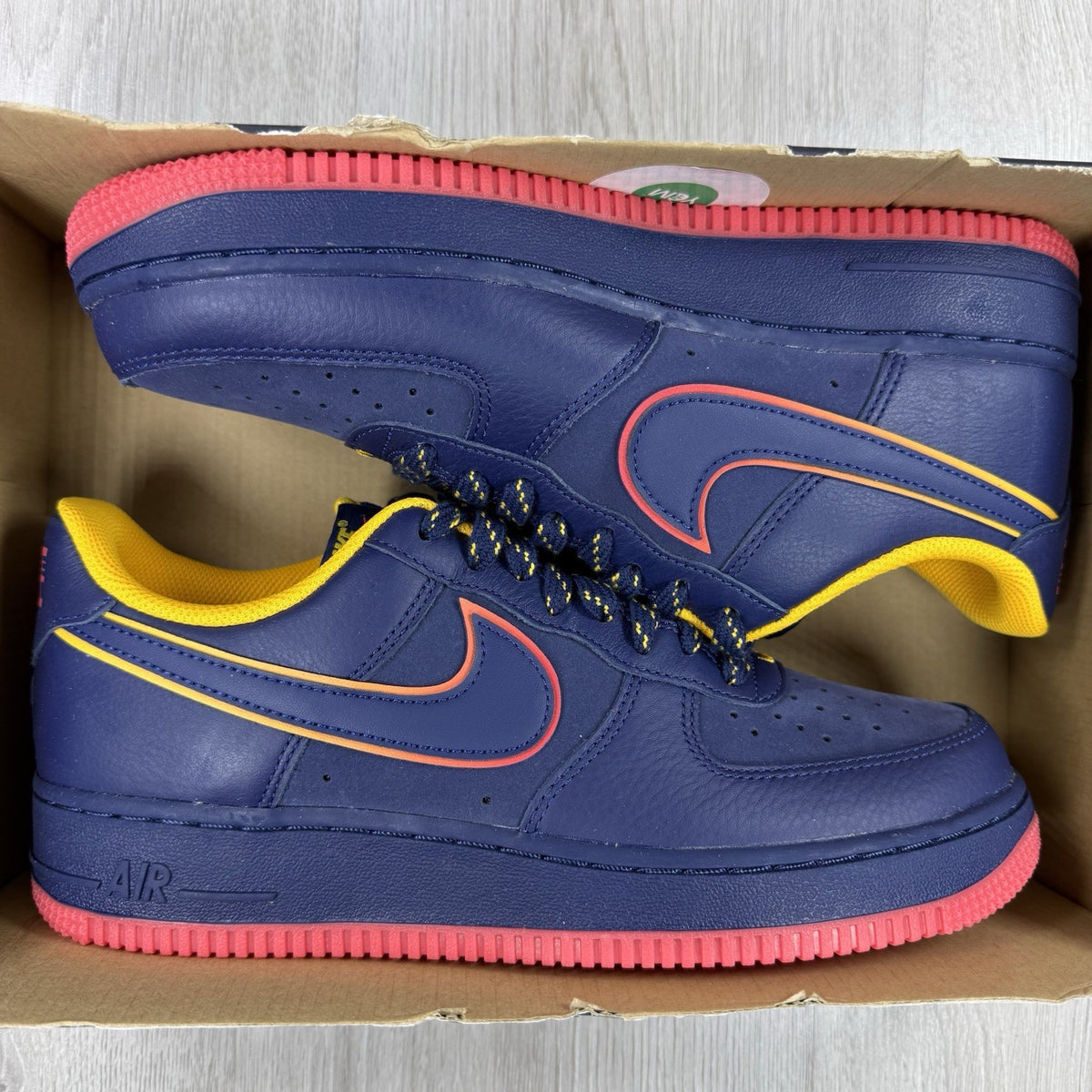 Nike blue trainers with gold accents and retro design elements.