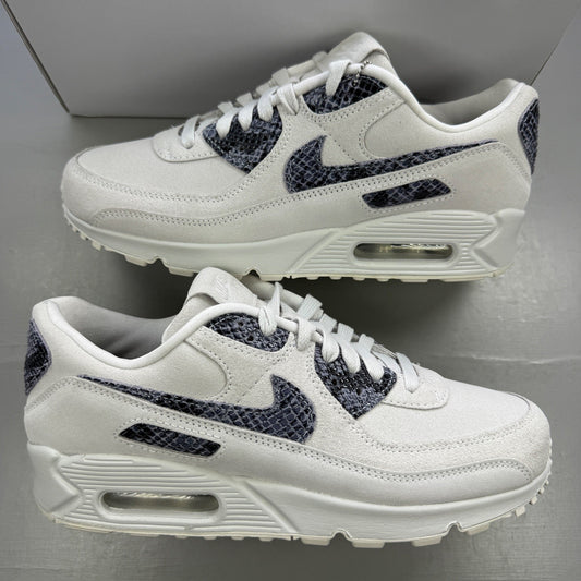 Nike trainers white with black snakeskin pattern and signature swoosh logo.