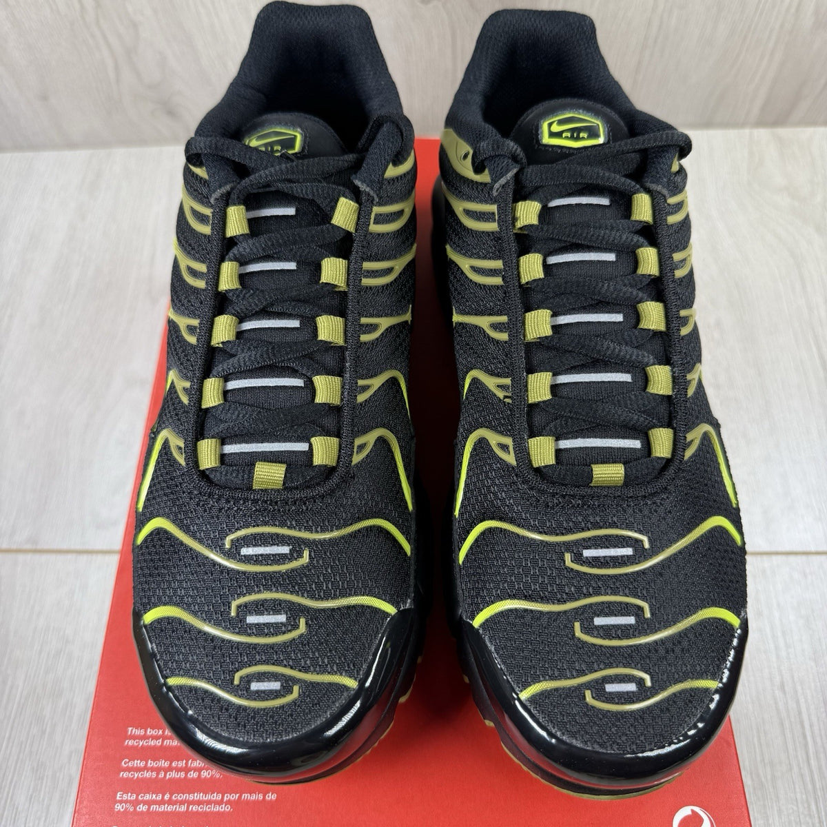Nike Air Max Plus TN trainers black with moss green accents and signature logo.