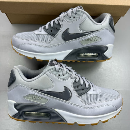 Nike Air Max 90 grey trainers with gum sole and iconic swoosh logo.