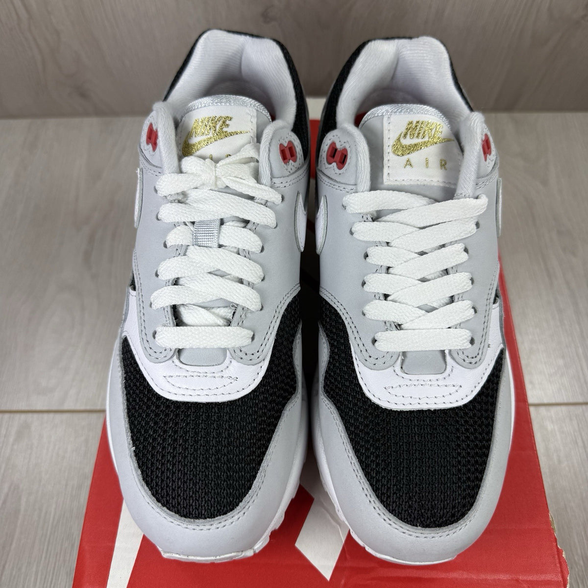 Nike Air Max 1 trainers grey with white accents and signature swoosh logo.