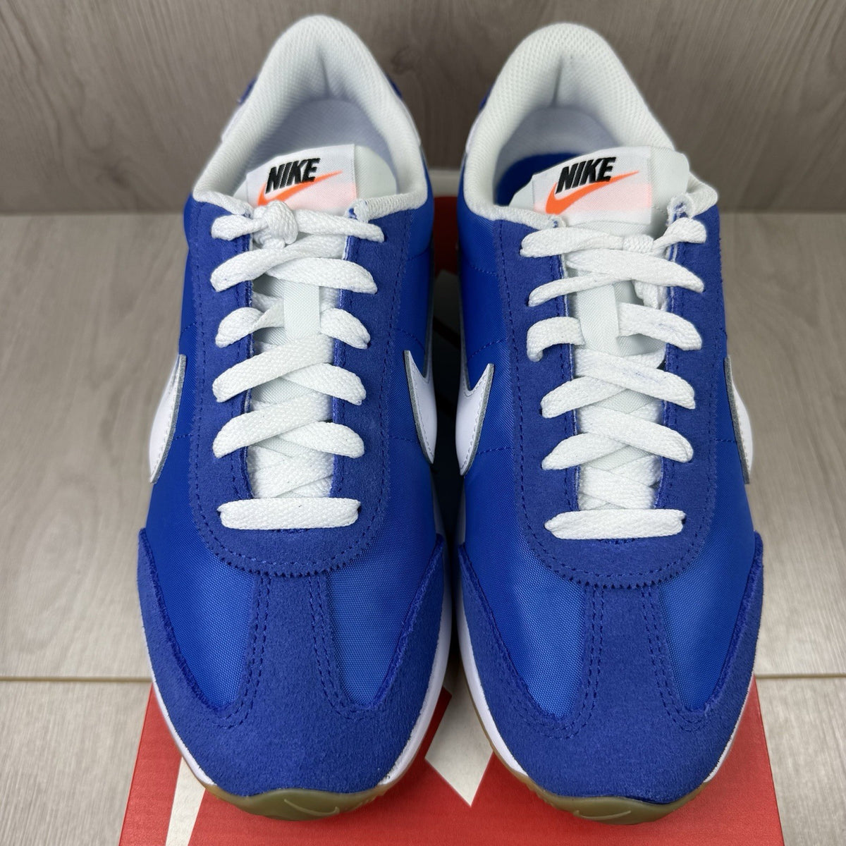 Nike blue trainers with white swoosh logo and mesh upper details.