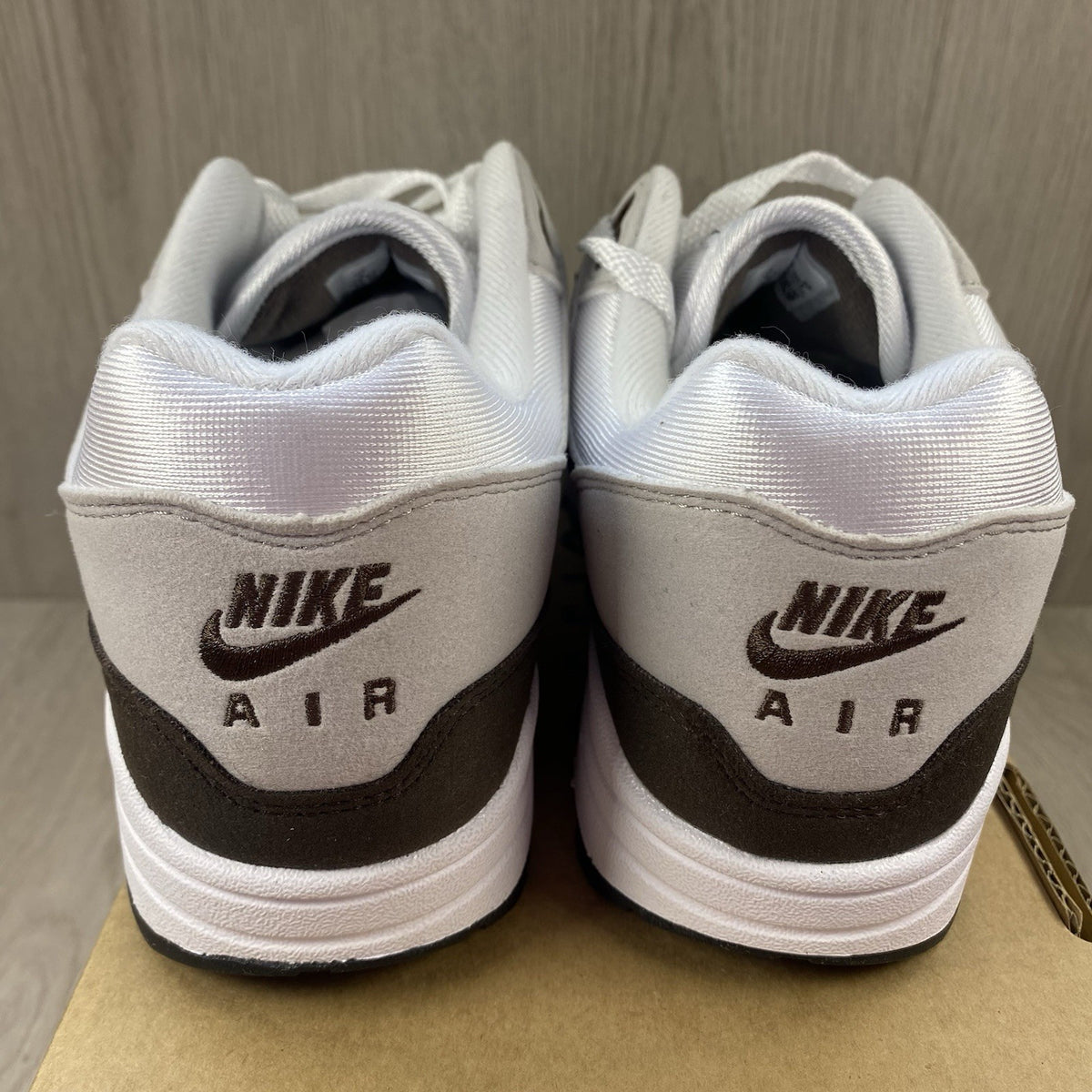 Nike Air Max 1 '87 trainers white with grey accents and brown detailing.