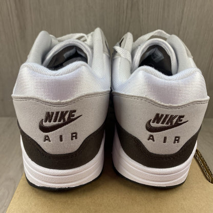 Nike Air Max 1 '87 trainers white with grey accents and brown detailing.