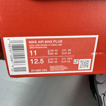 Nike Air Max Plus TN grey trainers with white and liquid lime accents, logo detail.
