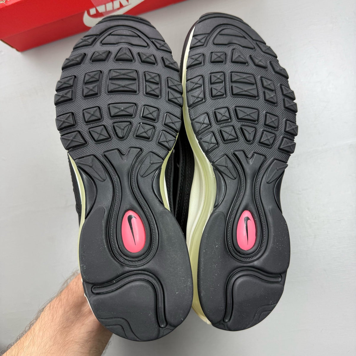 Nike Air Max 98 black trainers with crimson and pink accents, mesh and leather material.