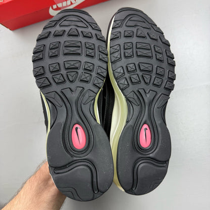 Nike Air Max 98 black trainers with crimson and pink accents, mesh and leather material.