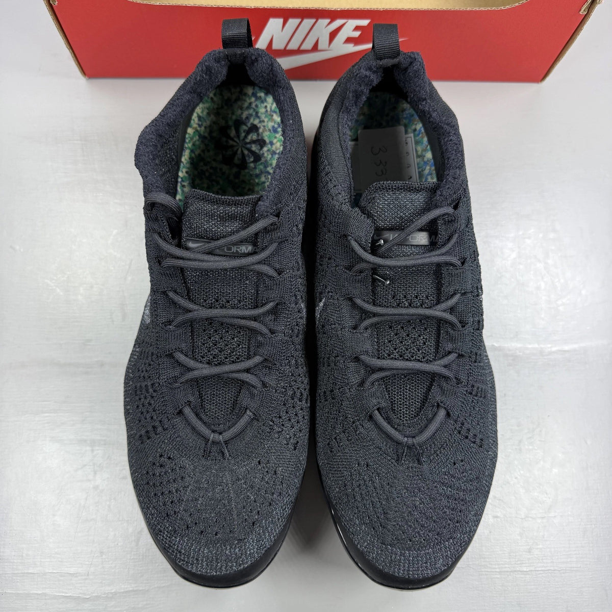 Nike Air VaporMax 2023 black Flyknit sneakers with visible logo and sleek design.