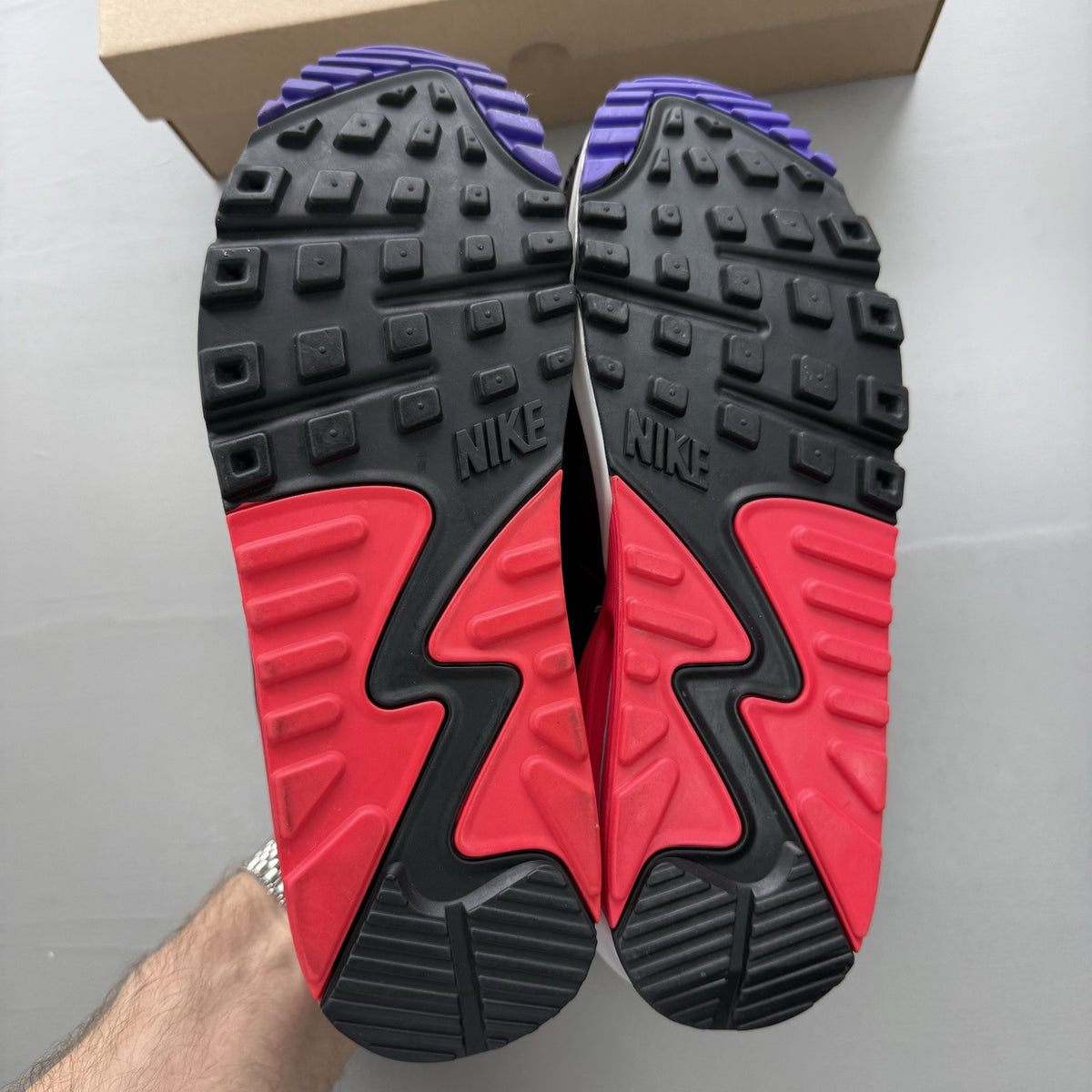 Nike Air Max 90 Raptors white trainers with red, purple, and black accents.