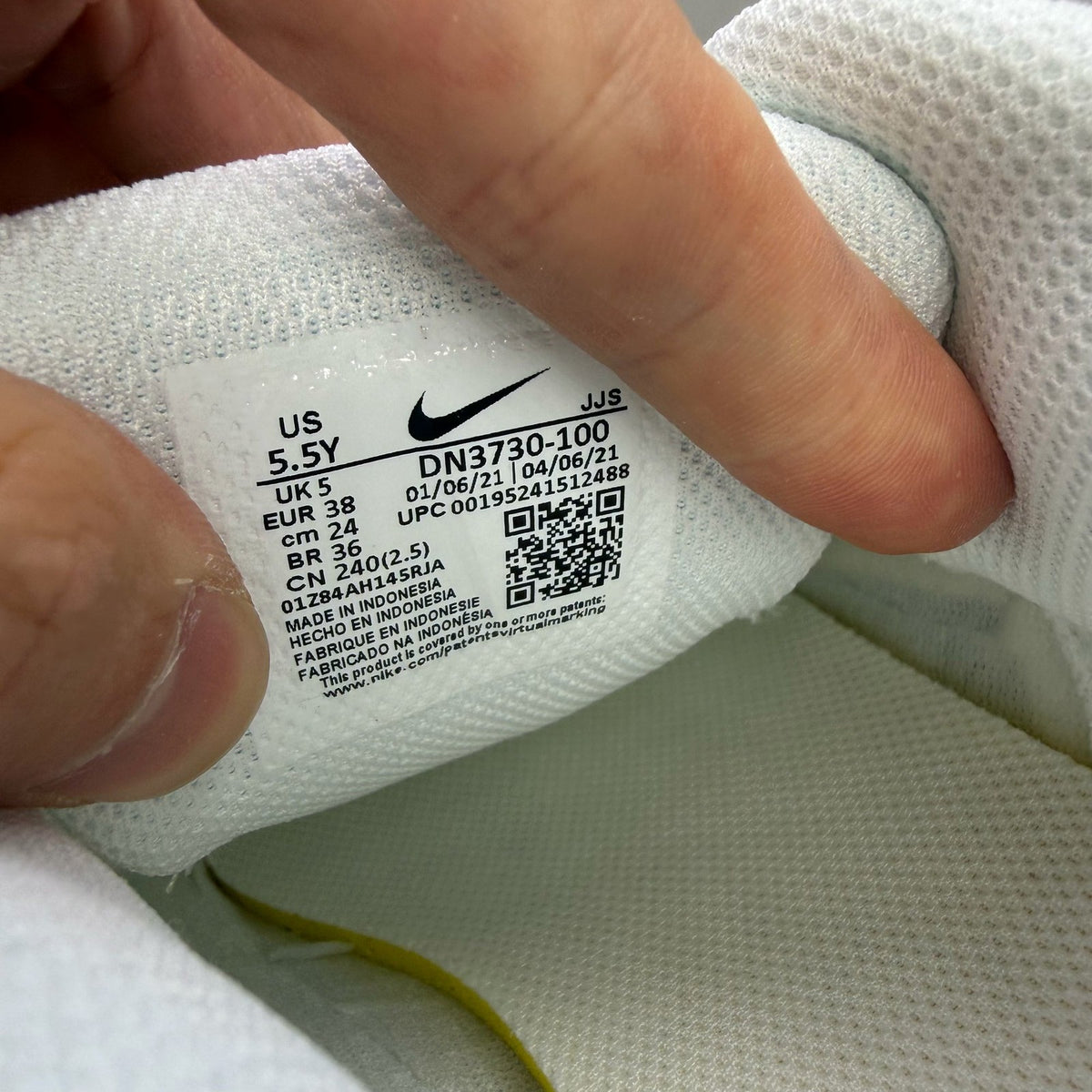 Nike Air Max 90 GS white trainers with multi-coloured Swoosh logo and mesh detailing.