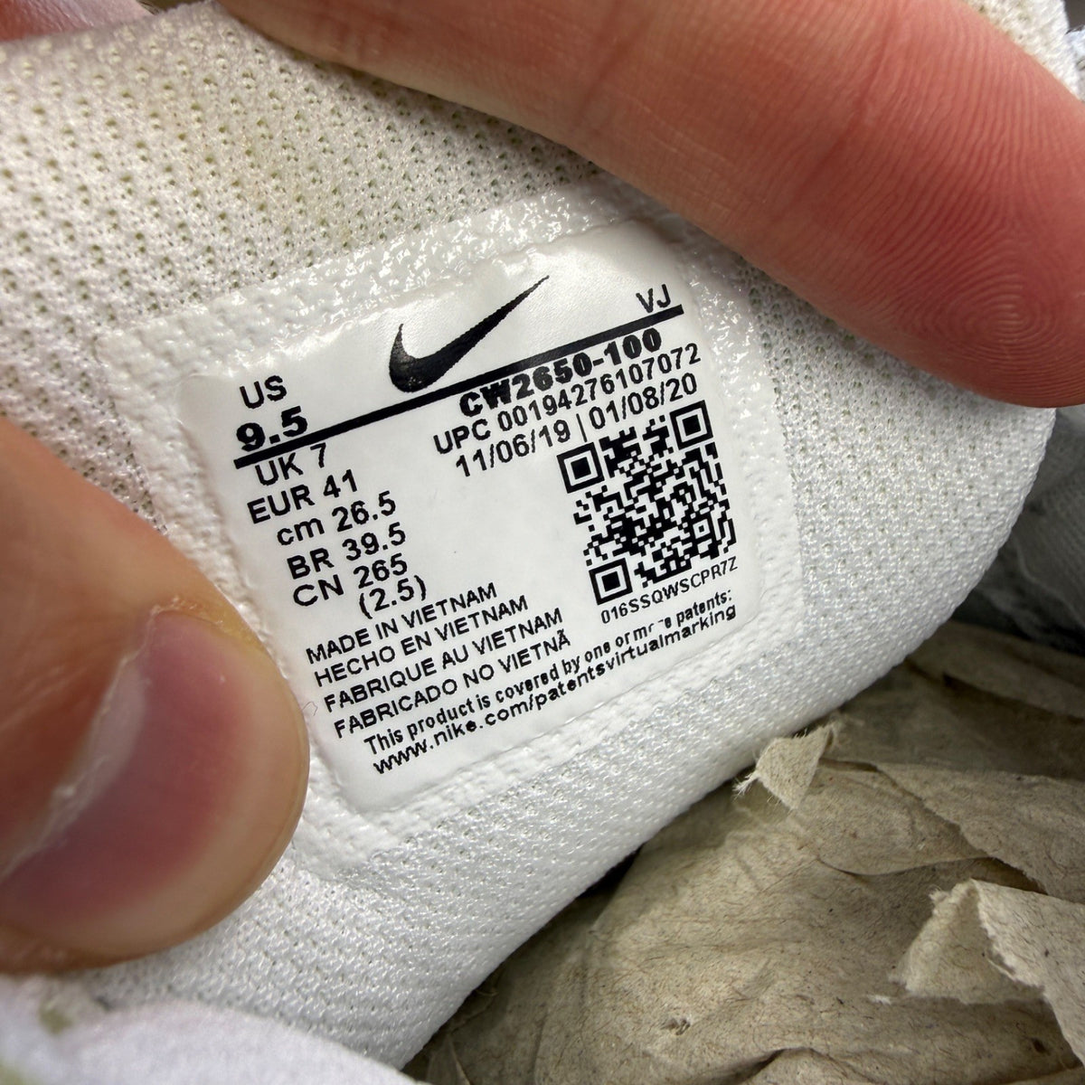 Nike white trainers with lemon venom accents and Air Max logo detail.