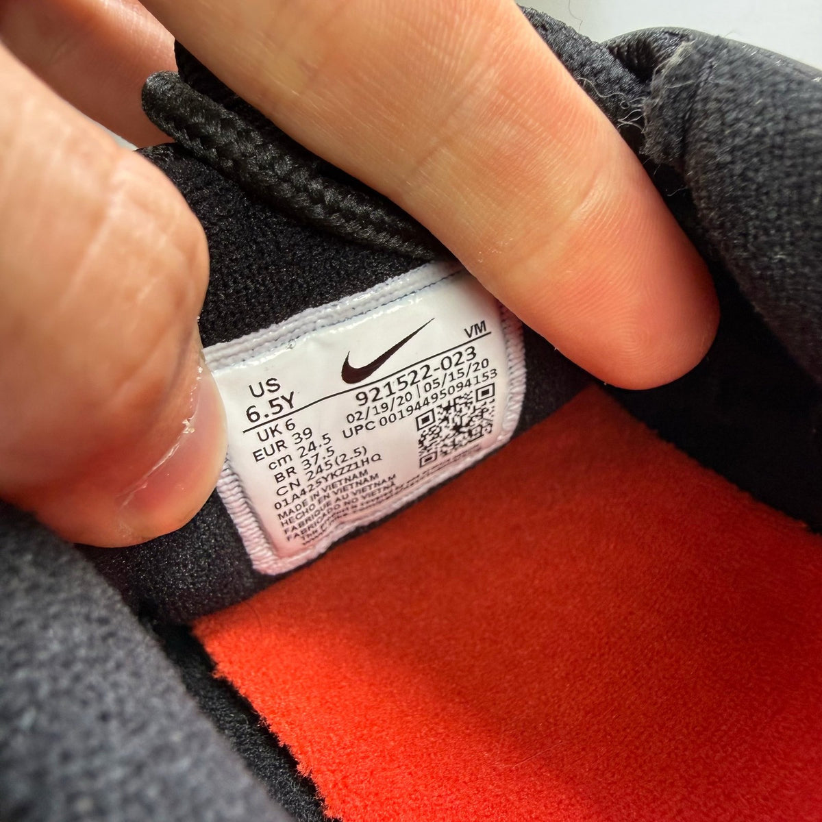Nike Air Max 97 black trainers with red accents and signature logo details.