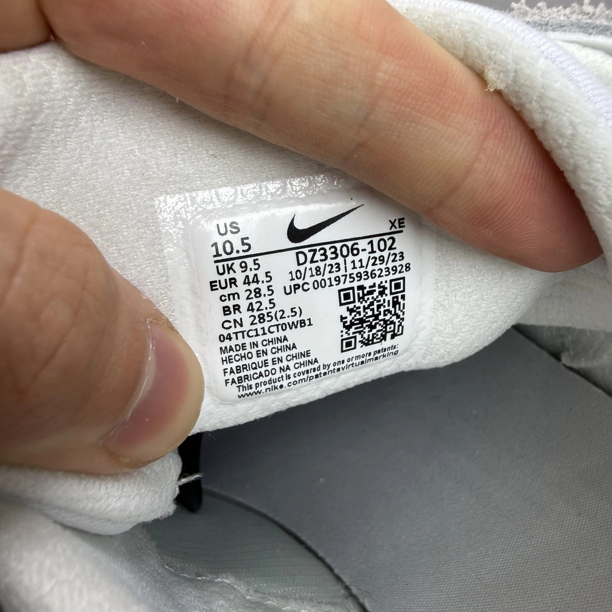 Nike Air Huarache Runner white trainers with red accents and signature logo.