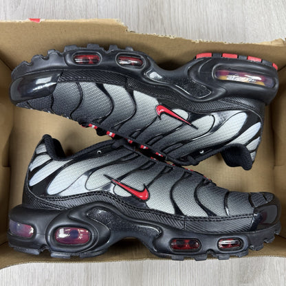 Nike TN Air Max Plus trainers black with red gradient and signature logo design.