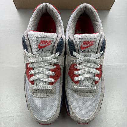 Nike Air Max 90 trainers white with red and navy accents, featuring logo details.